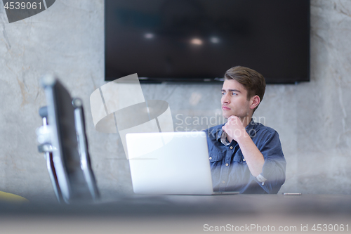 Image of businessman working using a laptop in startup office