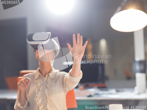 Image of businesswoman using VR-headset glasses of virtual reality