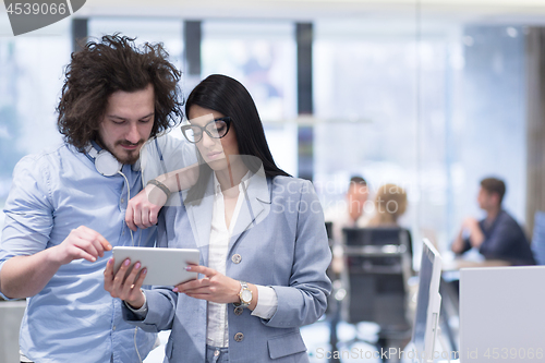 Image of Business People Working With Tablet in startup office