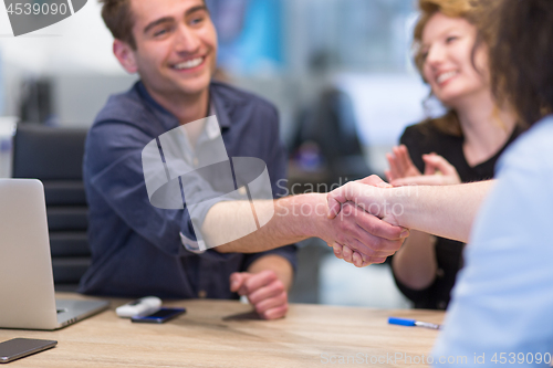 Image of cloasing the deal in modern office interior