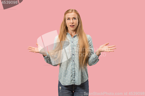 Image of Beautiful woman looking suprised isolated on pink