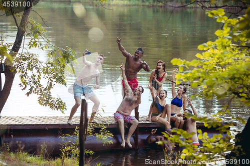 Image of Enjoying river party with friends. Group of beautiful happy young people at the river together