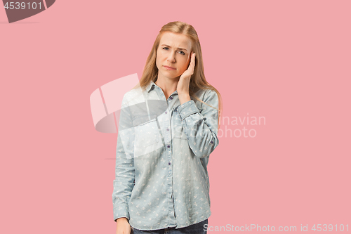 Image of Woman having headache. Isolated over pink background.