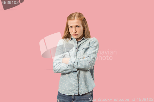 Image of Portrait of an angry woman looking at camera isolated on a pink background