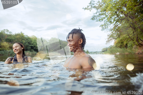 Image of Enjoying river party with friends. Group of beautiful happy young people at the river together