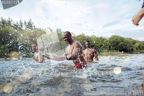 Image of Enjoying river party with friends. Group of beautiful happy young people at the river together