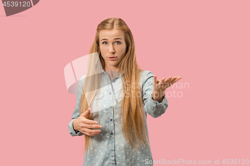 Image of Beautiful female half-length portrait isolated on pink studio backgroud. The young emotional surprised woman