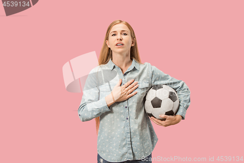 Image of Fan sport woman player holding soccer ball isolated on pink background