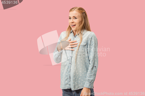 Image of The happy business woman standing and smiling against pink background.