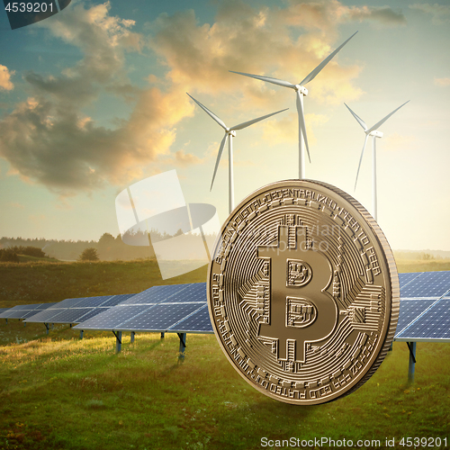 Image of Gold coin bitcoin on a green field against the sky and solar panels. Eco mining concept