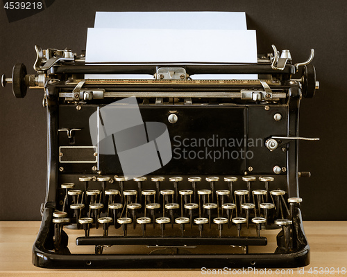 Image of Vintage typewriter with blank sheet of paper retro technology