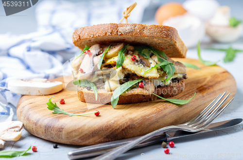 Image of Sandwich with mushroom and scrambled eggs for Breakfast.