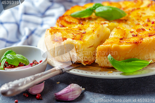 Image of Piece of tarte tatin pie with potatoes close-up.