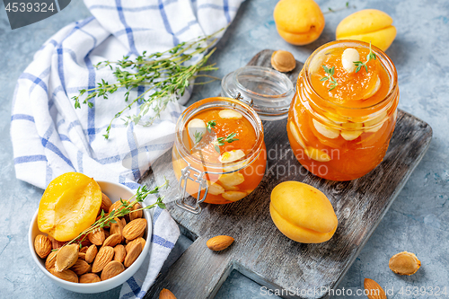Image of Jars of homemade apricot jam with almonds.