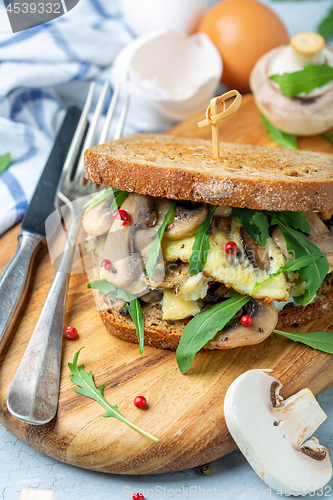 Image of Toasted bread sandwich with mushrooms and scrambled eggs.