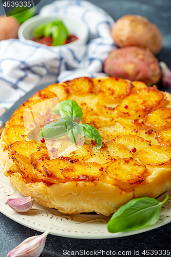 Image of Traditional Tarte Tatin with potatoes and garlic.