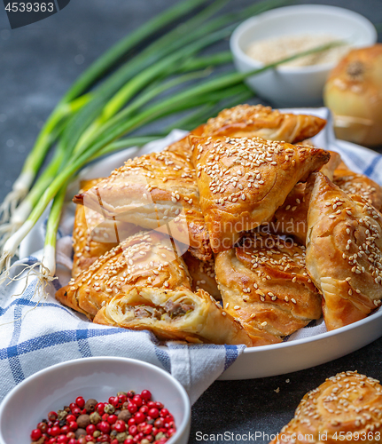 Image of Homemade samosas with meat and spices.