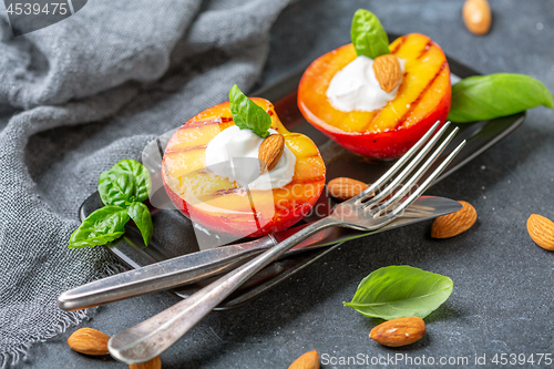 Image of Grilled peach with honey, yogurt and almonds.