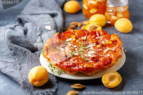 Image of Homemade tarte tatin pie with apricots and thyme.