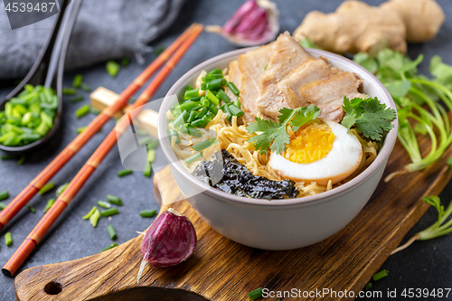 Image of Spicy soup with noodles and meat in Asian style.