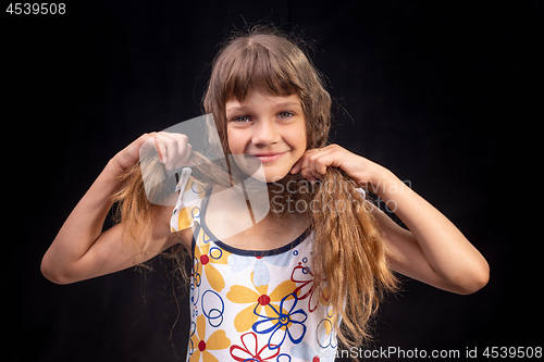 Image of Portrait of a girl who made a headscarf out of hair on her head