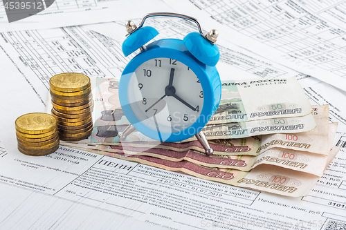 Image of Watches, paper rubles, coins on receipts with penalties for payment