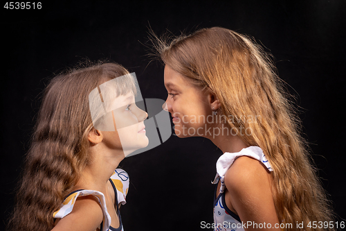Image of Two girls look at each other face to face