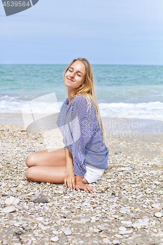 Image of Beautiful happy girl on the Adriatic beach. Travel and vacation.
