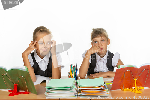 Image of Two girls thought about an abstract topic while sitting at a desk at school