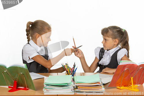 Image of Two girls fight with pencils at a school desk