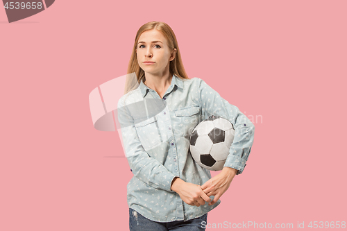 Image of Fan sport woman player holding soccer ball isolated on pink background