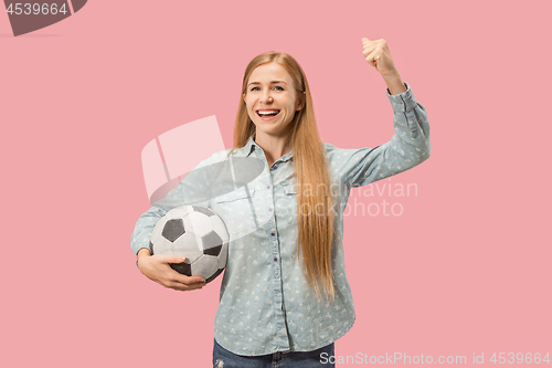 Image of Fan sport woman player holding soccer ball isolated on pink background