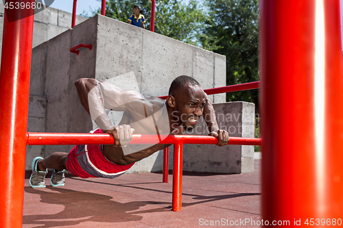 Image of Athlete doing exercises at stadium