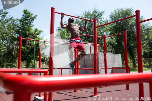 Image of Athlete doing exercises at stadium