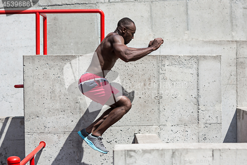 Image of Athlete doing exercises at stadium