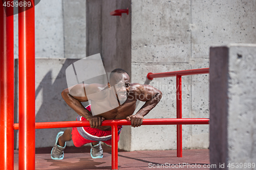 Image of Athlete doing exercises at stadium