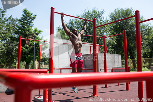 Image of Athlete doing exercises at stadium