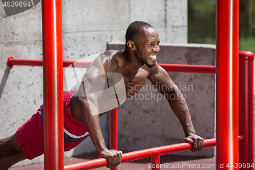 Image of Athlete doing exercises at stadium