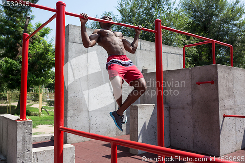 Image of Athlete doing exercises at stadium