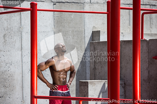 Image of Athlete doing exercises at stadium