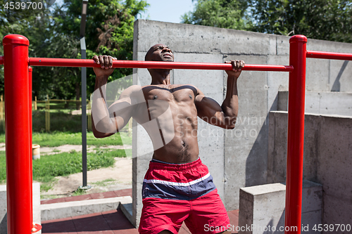 Image of Athlete doing exercises at stadium