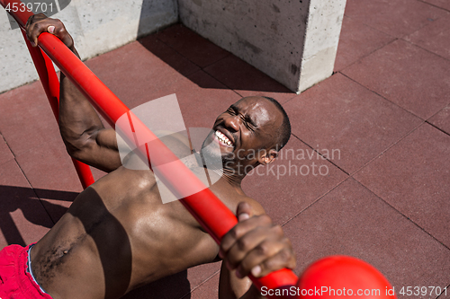 Image of Athlete doing exercises at stadium