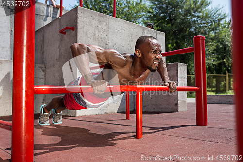 Image of Athlete doing exercises at stadium