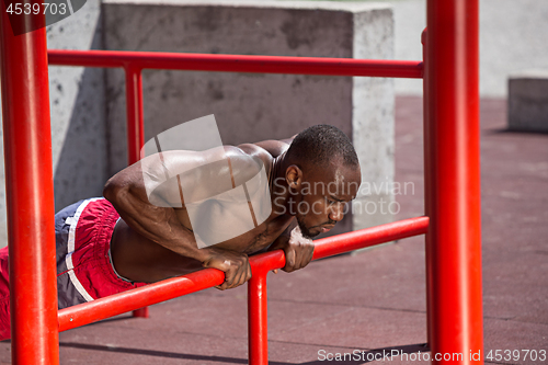 Image of Athlete doing exercises at stadium