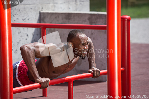 Image of Athlete doing exercises at stadium