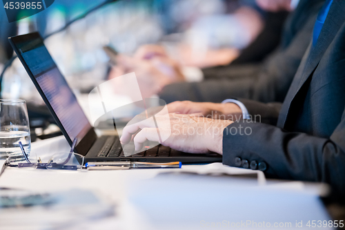 Image of close up of business people hands using laptop computer