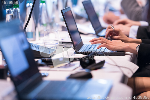 Image of close up of business people hands using laptop computer