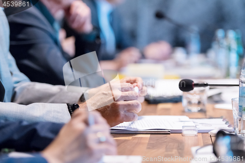 Image of close up of business people taking notes