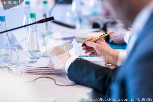 Image of close up of business people taking notes