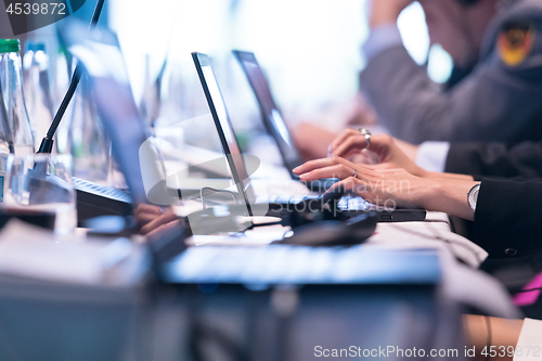 Image of close up of business people hands using laptop computer